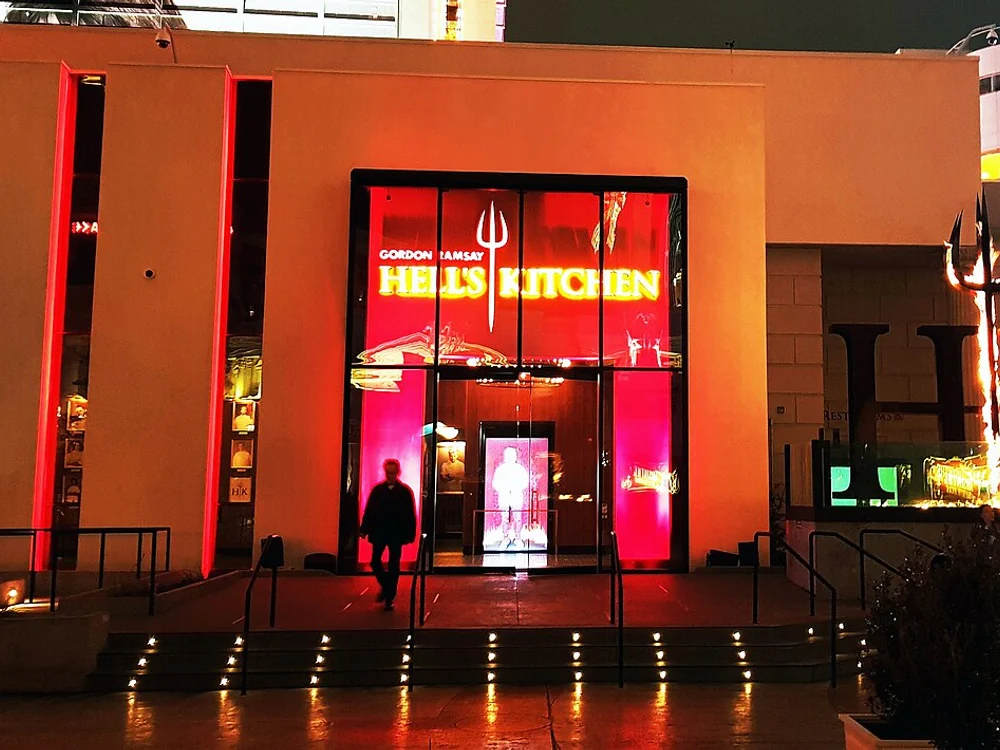 Hell’s Kitchen glass pavilion with blazing pitchfork monument on Las Vegas Blvd