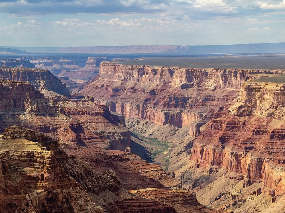 Maverick Airbus EC130 ECO-Star helicopter parked on canyon floor landing pad