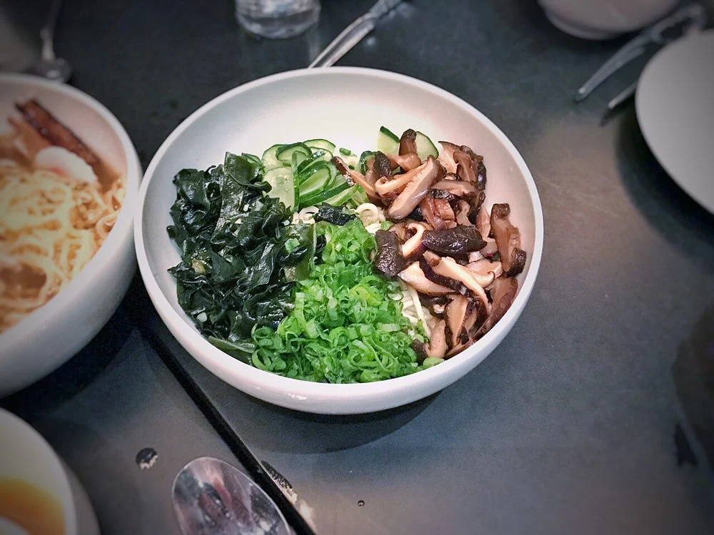 Momofuku entrance and open kitchen noodle counter on Cosmopolitan Level 2