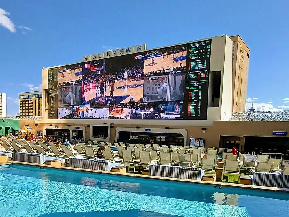Tiered 6-pool amphitheater facing the massive 143-foot LED screen